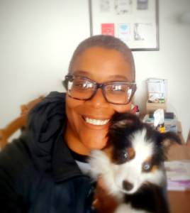 Pet Sitter Millicent with a smiling puppy